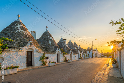 Trulli houses in Alberobello city at sunset time, Apulia, Italy