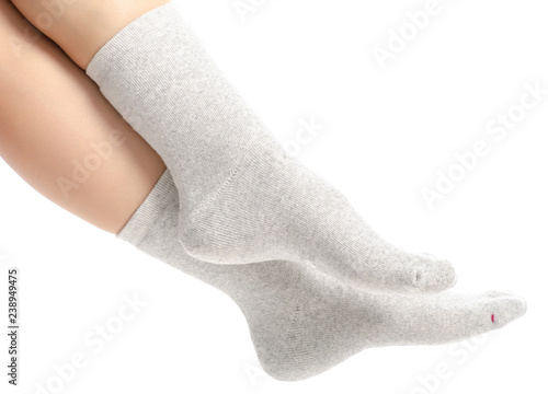 Female legs in gray socks on white background. Isolation