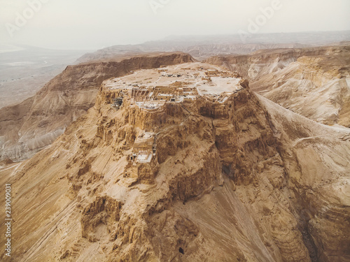 Masada fortress area Southern District of Israel Dead Sea area Southern District of Israel. Ancient Jewish fortress of the Roman Empire on top of a rock in the Judean desert, front view from the air