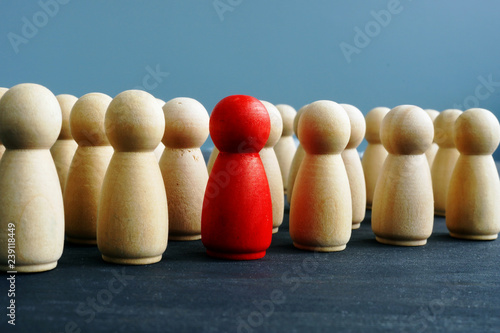 Difference, dissimilarity and distinctness concept. Wooden figures on a desk.