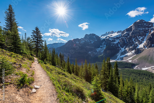Amazing view of sunny touristic trail in the Rocky Mountains. The trail in mountains near Moraine lake in Canadian Rockies, Banff National Park, Canada.
