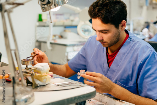 Caucasian man working on a dental prosthesis