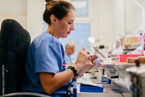 Caucasian woman working with dental prosthesis