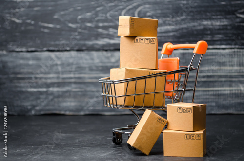 A supermarket cart loaded with cardboard boxes. Sales of goods. concept of trade and commerce, online shopping. high. delivery order. purchasing power of the population and the state of the economy