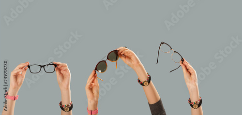 hands holding eyeglasses