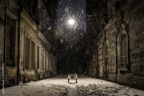 Empty bench on a dark alley