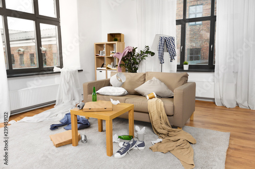 mess, disorder and interior concept - view of messy home living room with scattered stuff