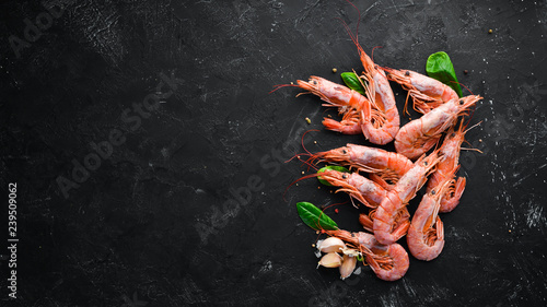 Large shrimp with lemon. Top view. Free space for your text. On the old background.