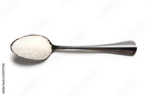 Teaspoon of sugar on a white background isolation top view