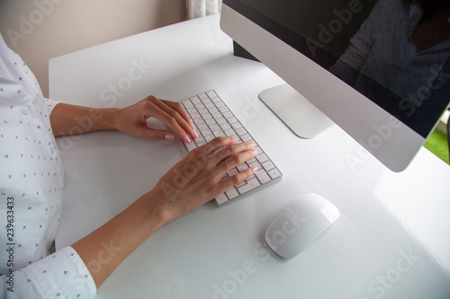 hands of a girl typing on a keyboard with a Russian layout