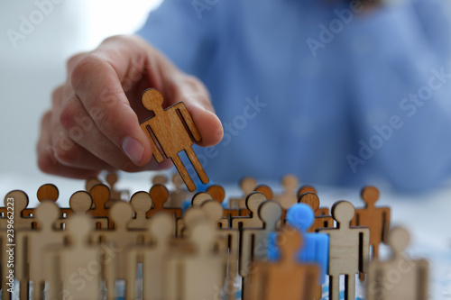 Businessman in blue shirt is holding a magnifying