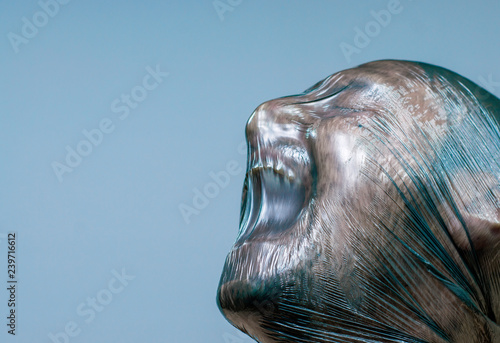 A man with a plastic bag over his head is suffocating.