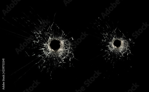Glass with cracks and a hole from firearms
