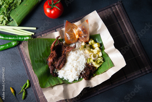 nasi lemak kukus with quail meat top view, malaysian local food