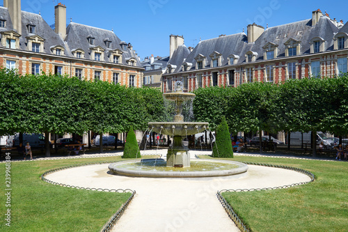 Empty Place des Vosges in Paris in a sunny summer day, clear blue sky