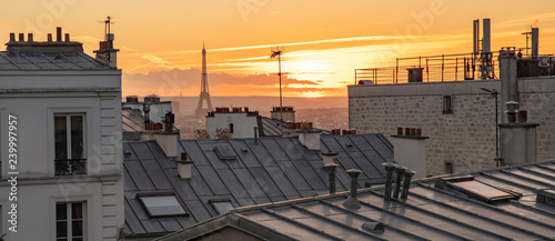 The Eiffel Tower and the rooftops of Paris seen from Montmartre with a sunset