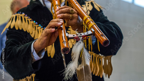 Close up of a Native American Indian playint at flute.