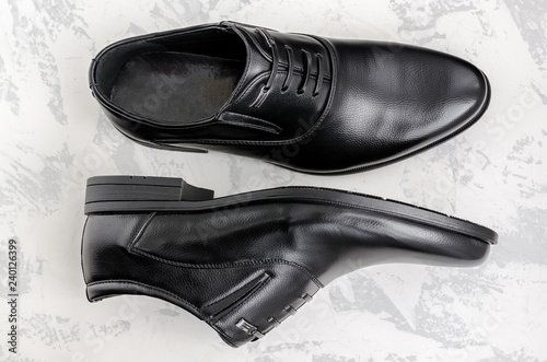 Men's shoes made of black leather on a light background.