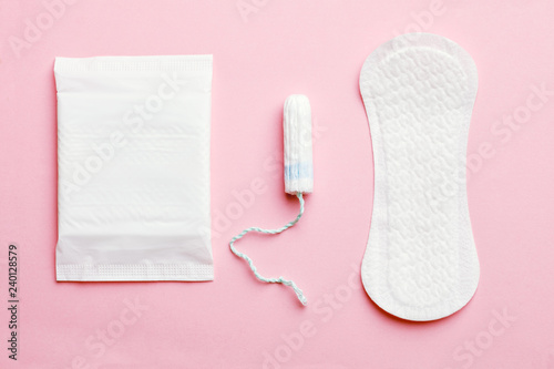 women intimate hygiene products - sanitary pads and tampon on pink background