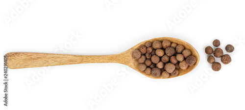Allspices or Jamaica pepper in wooden spoon isolated on white background. Top view