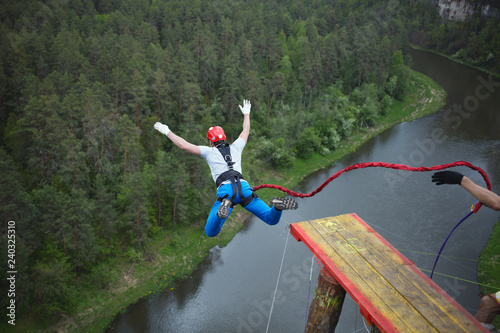 An extreme sportsman jumps on a rope from a great height. Ropejumping.