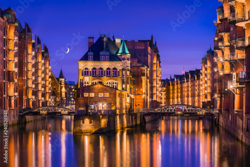 The Warehouse District (Speicherstadt) in Hamburg, Germany, at night. View of Wandrahmsfleet. The largest warehouse district in the world is located in the port of Hamburg in the HafenCity quarter.