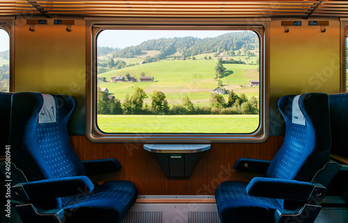 Swiss rural farmland through train window, Train travel concept.