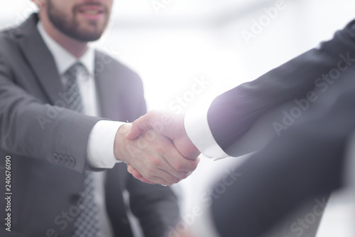 Two colleagues shaking hands after a business meeting