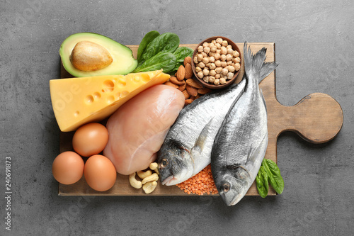Set of natural food high in protein on grey background, top view