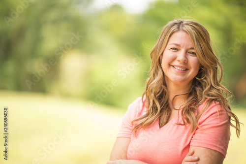 Portrait of a happy woman smiling outside.