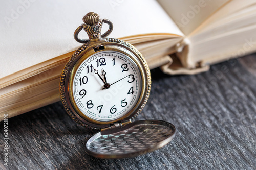 Vintage pocket watch with open book
