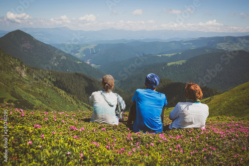 Travelers, friends relax on the mountain trail