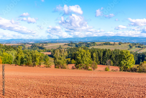 Typical red soil of countryside around Nova Paka. Agricultural Landscape with Giant Mountains on the background. Czech Republic.