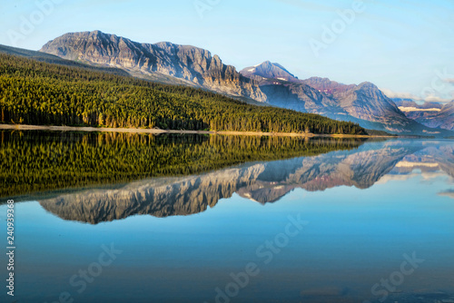 Beautiful lakes with reflections in morning light in Glacier National Park.