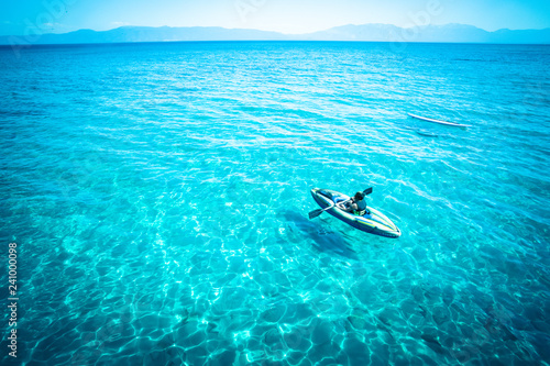 View from Lake Tahoe with tropical blue color water and canoe