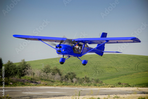  a blue plane manned by student and flight instructor of a class flight practice