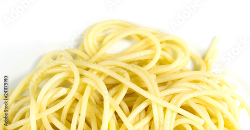 Raw Spaghetti on white background. Yellow italian pasta. Food wallpaper background concept..