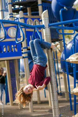 Girl Tween at Park Hanging from Monkey bars Playground