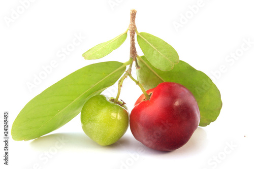 fresh organic acerola with green leaves, isolated on white background with clipping path