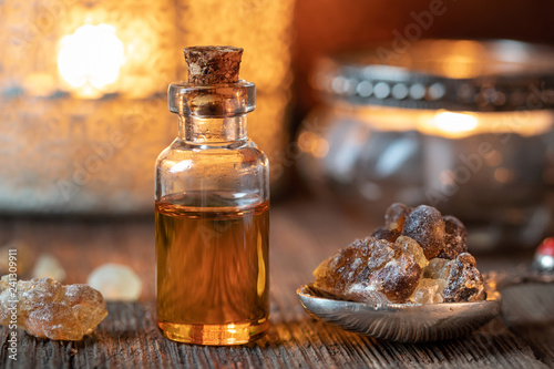 A bottle of frankincense essential oil with frankincense resin crystals