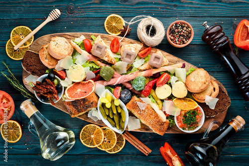 A set of food. Snacks of Italian cuisine. On a wooden background. Top view. Free copy space