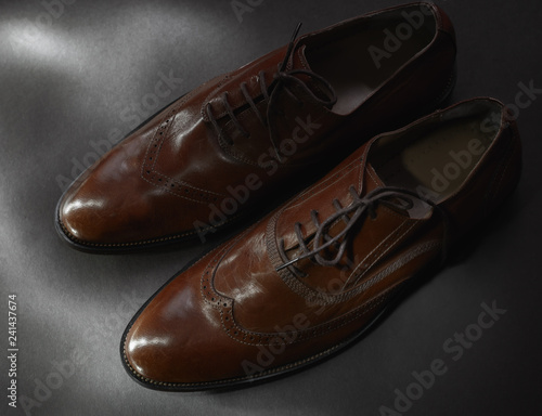 brown leather shoes on gray background