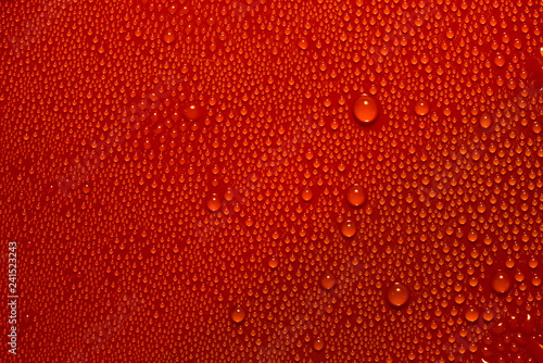 Abstract bright water drops texture on red background