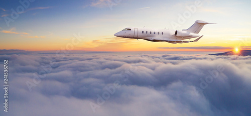 Luxury private jetliner flying above clouds.