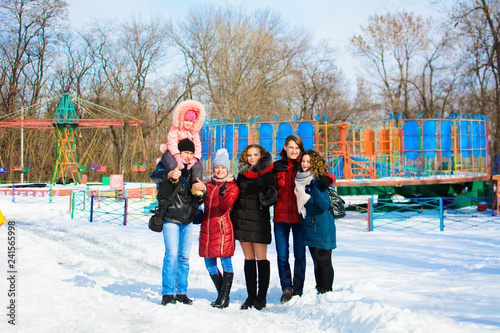group of friends posing in the park in winter