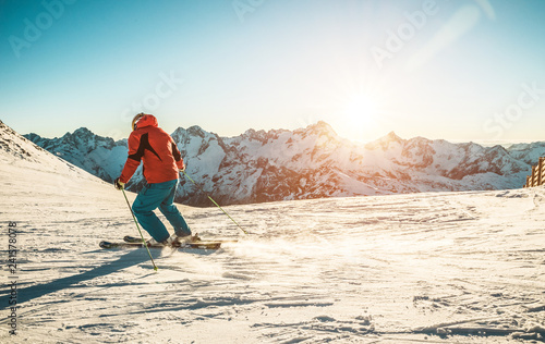 Young man skiing in alps mountains on sunny day