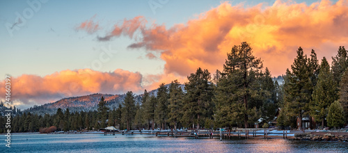 Beautiful sunset views of the shoreline of South Lake Tahoe, houses visible among pine trees