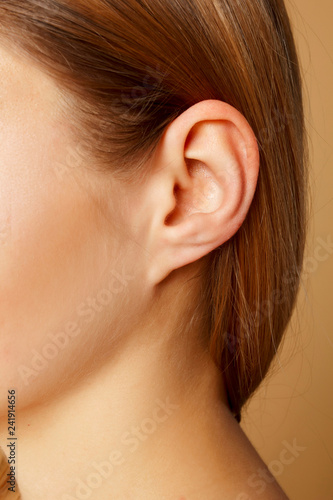 Detail of the head with female human ear and hair close up