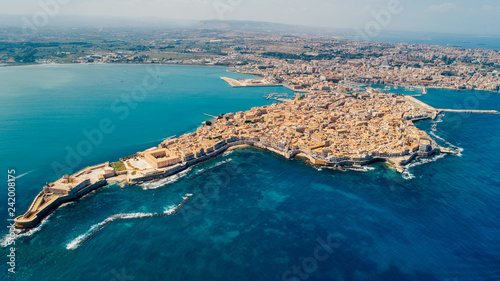 Aerial panoramic view of Ortigia island,old town of Syracuse.Small island on Sicily,Italy.Sicilian vacation,charming Italian experience.Beautiful seaside landscape