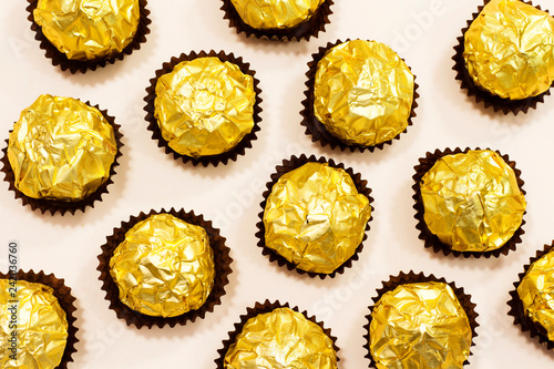 golden premium chocolate sweets isolated on pink background